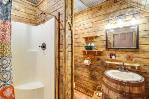 a bathroom with a sink and a wooden wall at Rural Arkansas Vacation Rental with Wraparound Porch in Heber Springs +16 photos