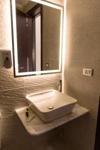 a white sink in a bathroom with a mirror at Tourist Palace Hotel in Cairo