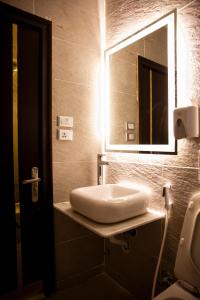 a bathroom with a sink and a mirror at Tourist Palace Hotel in Cairo