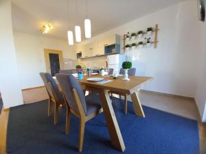 a dining room with a wooden table and chairs at Apartments Villa Ornamenta - 5min to beach - free parking in Kaštela