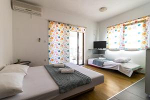 a bedroom with two beds and a window at Ankica & Anamarija Apartments in Neum