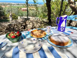 a table with plates of food and fruit on it at le finestre sul mare in Conversano
