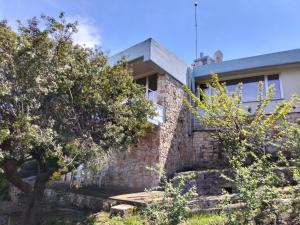 a brick house with trees in front of it at le finestre sul mare in Conversano