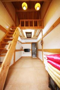 a room with two bunk beds and a staircase at Gawondang in Jeonju