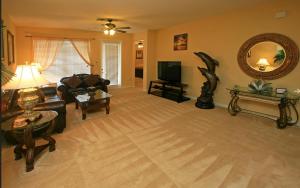 a living room with a couch and a tv at Executive 3 Bedroom Villa at Universal in Orlando