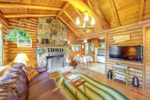 a living room with a couch and a fireplace at Waterfront Newport Vacation Rental on Sacheen Lake in Newport