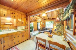 a kitchen and living room with a table in a cabin at Waterfront Newport Vacation Rental on Sacheen Lake in Newport