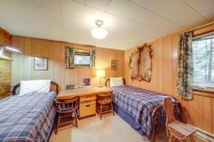 a bedroom with two beds and a desk and a desk at Waterfront Newport Vacation Rental on Sacheen Lake in Newport