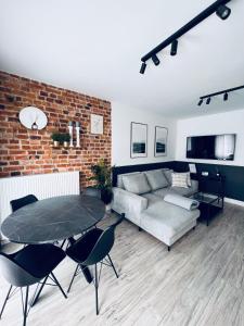 a living room with a couch and a table at Apartamenty Żary in Żary
