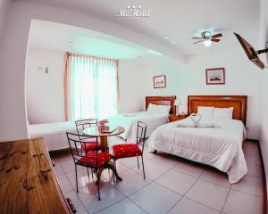 Cama ou camas em um quarto em Mc Hotel Ica