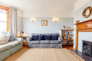 a living room with a couch and a fireplace at Wisteria in St Austell