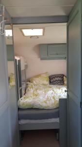 a small bedroom with a bed in a small room at Camping Prie Malūno in Žagarė