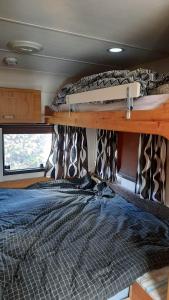 ŽagarėにあるSodyba Prie Malūnoのバン内の二段ベッド2台が備わるベッドルーム1室を提供しています。