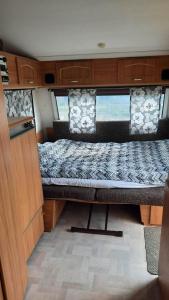 a bed in the back of a van at Camping Prie Malūno in Žagarė +36 photos