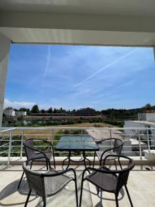 a patio with a table and chairs on a balcony at Apartments Fati & Flori in Ulcinj