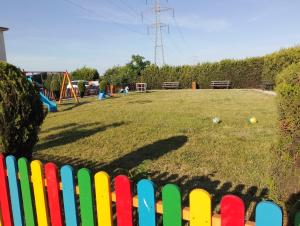 a fence in front of a yard with a playground at apartament eforie nord in Eforie Nord