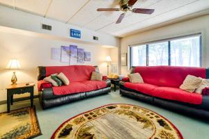 a living room with two red couches and a rug at 1 Mi to Big Boulder Lakefront Unit with Pool Access in Lake Harmony