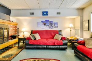 a living room with a red couch in a room at 1 Mi to Big Boulder Lakefront Unit with Pool Access in Lake Harmony