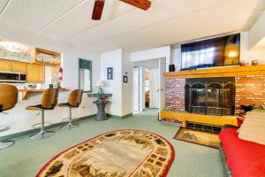 a living room with a fireplace and a tv at 1 Mi to Big Boulder Lakefront Unit with Pool Access in Lake Harmony