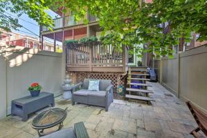 a patio with furniture and a balcony on a building at Contemporary Townhome in Midtown Harrisburg! in Harrisburg
