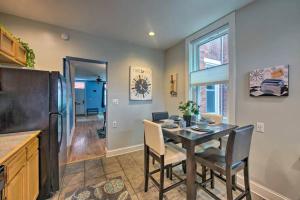 a kitchen with a table with chairs and a refrigerator at Contemporary Townhome in Midtown Harrisburg! in Harrisburg
