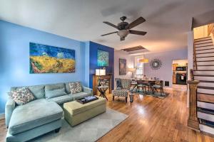 a living room with a couch and a ceiling fan at Contemporary Townhome in Midtown Harrisburg! in Harrisburg