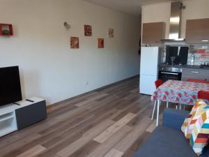 sala de estar con mesa y cocina en Appartamento ristrutturato - Castrocaro Terme, en Castrocaro Terme