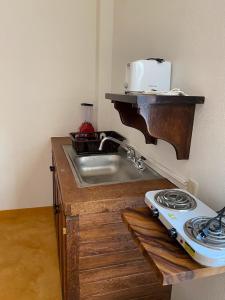 encimera de cocina con fregadero y fogones en Casa Suites Minizoo en Puerto Escondido