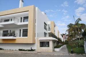 a white building with balconies and palm trees at Charming Cascais Apt. in Cascais