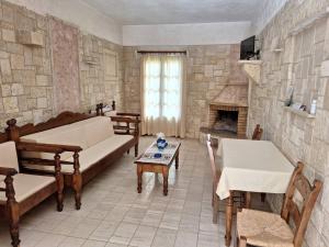 a living room with a couch and a fireplace at Mountain Vista Resort in Roústika