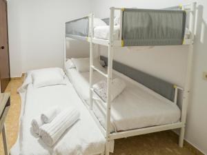 two bunk beds in a room with towels on them at MM DELTA HOLIDAYS in El Lligallo del Gànguil
