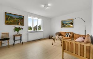 a living room with a couch and a table at Lovely Home In Nexø With Kitchen in Neksø