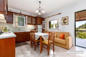 kuchnia i salon ze stołem i kanapą w obiekcie Matsas House & Studio w mieście Paleokastritsa