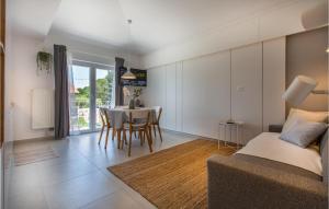 a living room with a couch and a table with chairs at Gorgeous Apartment In Izola With Kitchen in Izola