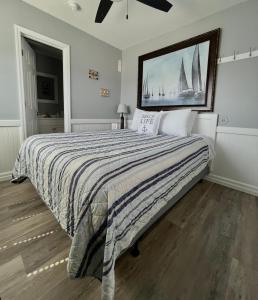 a bedroom with a large bed with a painting on the wall at Waterway Inn in Cedar Point