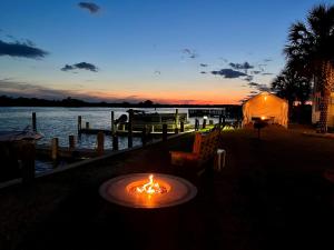 a lit table with a fire in front of a body of water at Waterway Inn in Cedar Point