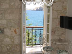 a door to a balcony with a view of the water at Apartments Authentic Baska 1 in Baška