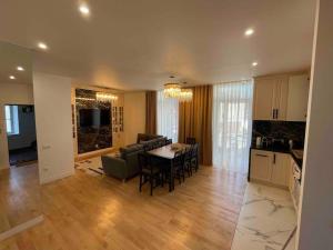 a kitchen and living room with a table and chairs at Confortable, au centre-ville in Saint-Claude