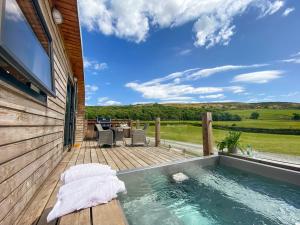 a lap pool on a deck with a table and chairs at Low Longlands in Cartmel