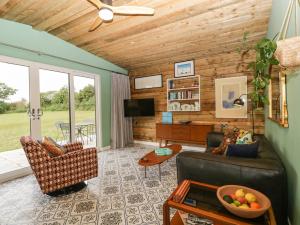 a living room with a couch and a table at Lulu Logs in Bristol