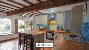 a kitchen with a island with a counter top at The historic Bulls Head-Grade II Listed in Chapel en le Frith