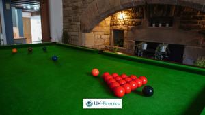 a pool table with red balls on top of it at The historic Bulls Head-Grade II Listed in Chapel en le Frith