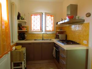 a kitchen with a sink and a stove at Casa Milena in Vallecchia