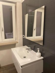 a bathroom with a sink and a mirror at A casa di NENÉ BeB in Lesina