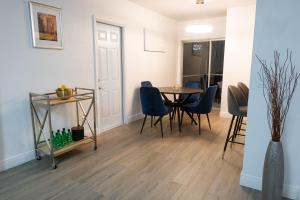 a dining room with a table and chairs at New Star Suite Two in North Miami Beach