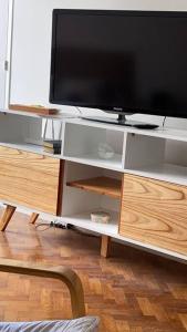 a tv on top of a white entertainment center at flat in Buenos Aires in Buenos Aires +9 photos