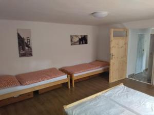 A bed or beds in a room at Ubytovanie Tibor Skarba
