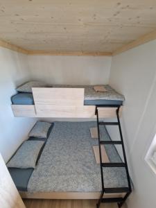 two bunk beds in a tiny house at Beach House Mane Sol - Perfect Seafront House For Relaxing Holidays in Drage