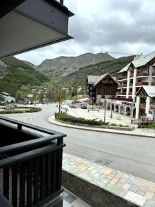 a view from a balcony of a town with a street at Appartement de luxe, parking sous-terrain, centre-ville Auron in Auron