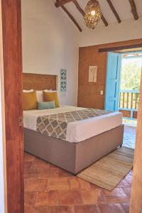 Casa Pumata Barichara في باريكارا: غرفة نوم بسرير كبير في غرفة